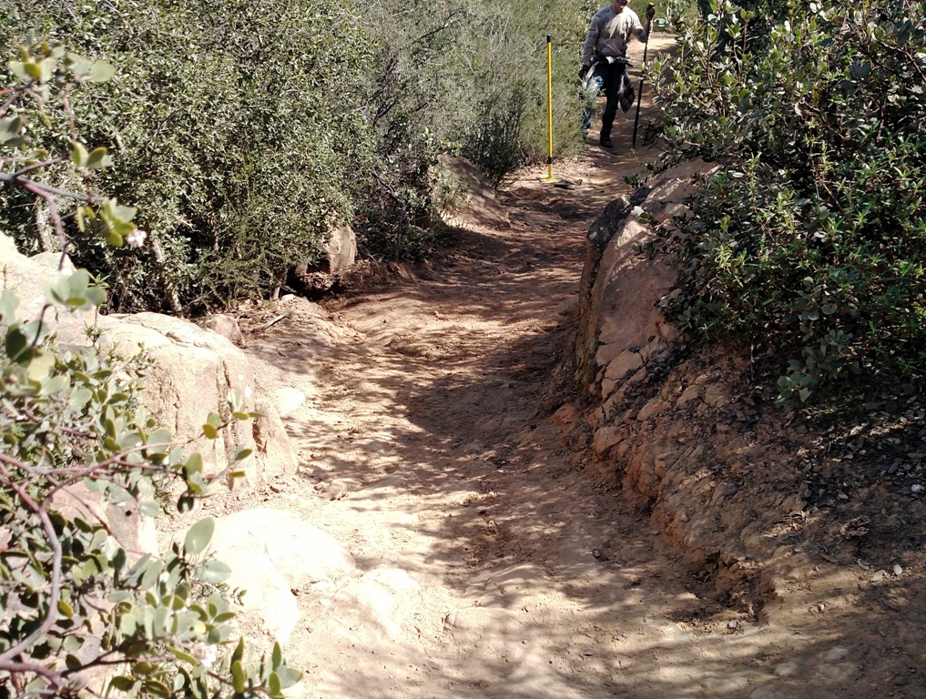 Trail maintenance - knocking down rock tips and reshaping for good drainage